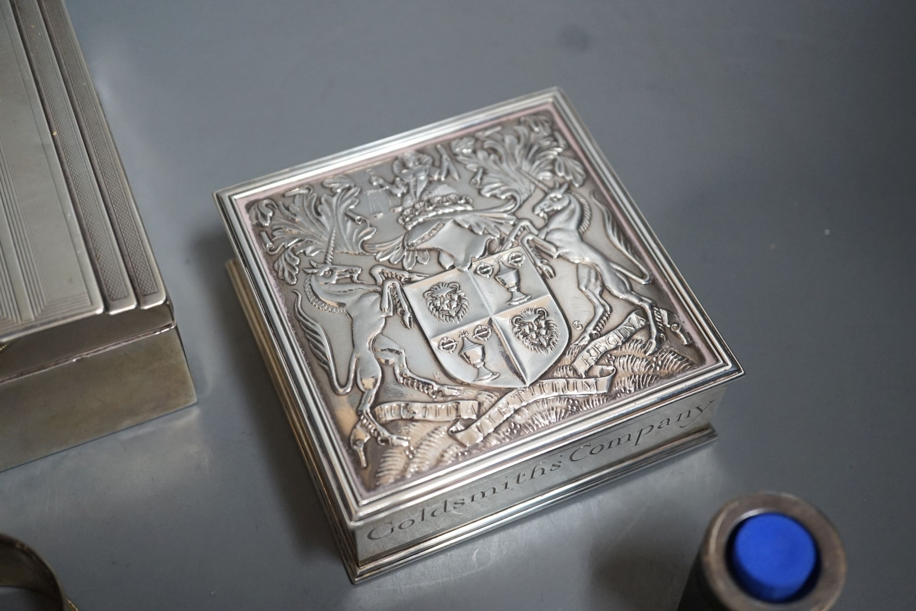 Sundry silver items including a George V 'The Gift of the Goldsmiths Company' box by Garrard & Co, London, 1926, 92mm, a silver cigarette case and box, four silver napkin rings, a cased silver christening trio and a silv